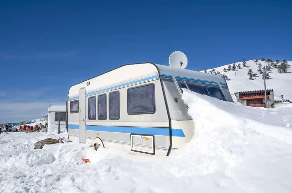 Image of a caravan filled with snow, depicting the challenges of cold climates