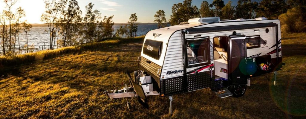 Caravan with awning extended and chairs outside, showcasing the relaxing atmosphere