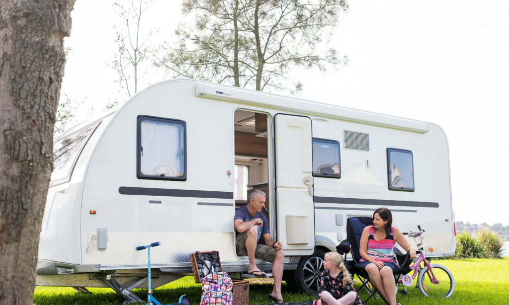 Caravan parked amidst picturesque mountains, highlighting the beautiful setting