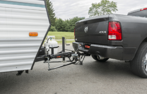 Truck safely towing a caravan on the road, with a sway control hitch for added stability