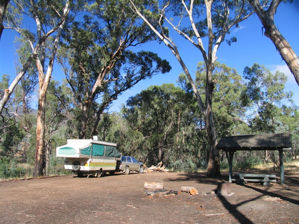 Secluded camping at Pinch River Camp, Kosciuszko National Park, with a caravan nestled beside the river