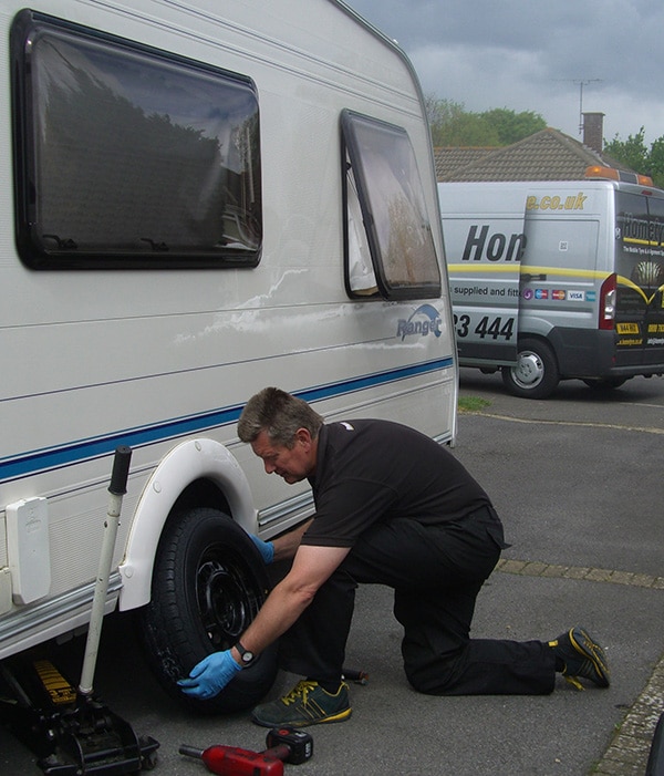 Expert car maintenance: technician checks wheels and tires for potential issues