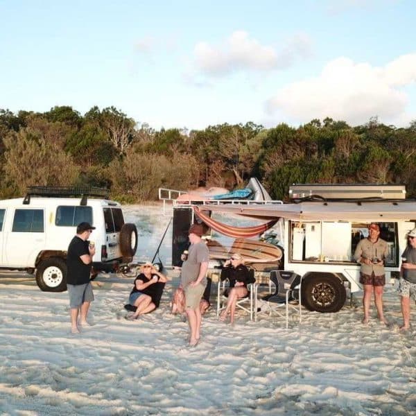 AllBrand Camping Adventures caravan parked beside a scenic beach, offering the perfect campsite getaway