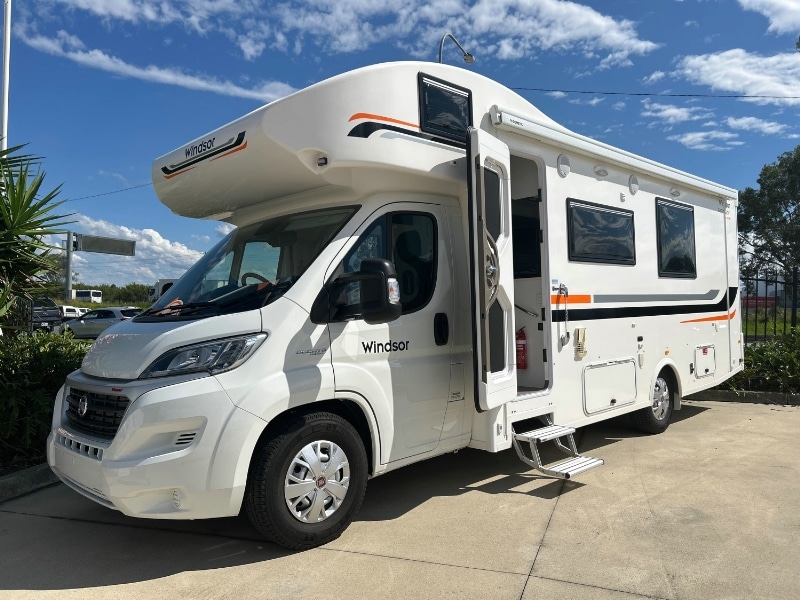 A white motorhome parked in a parking lot