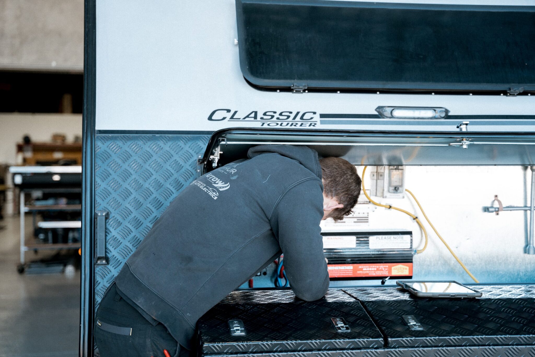 No more leaks! Technician fixing the caravan roof for worry-free travel