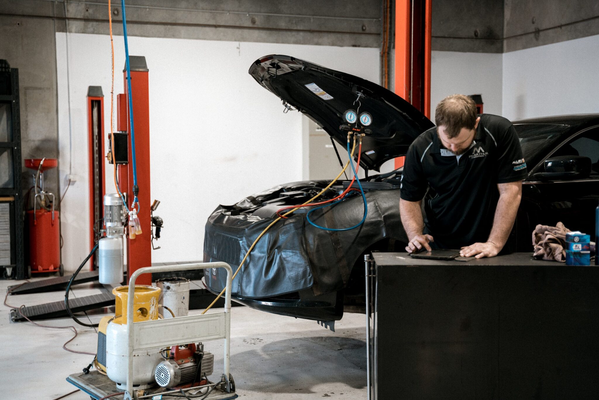 Getting your car back on the road: Technician servicing the engine for a smooth ride