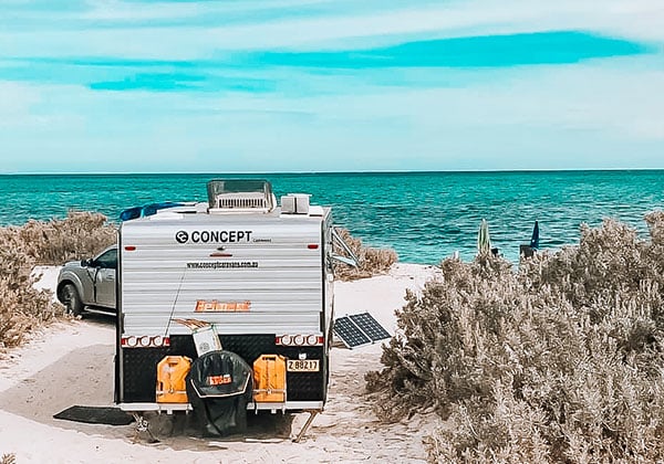 Caravan set up for camping on a beachfront campsite