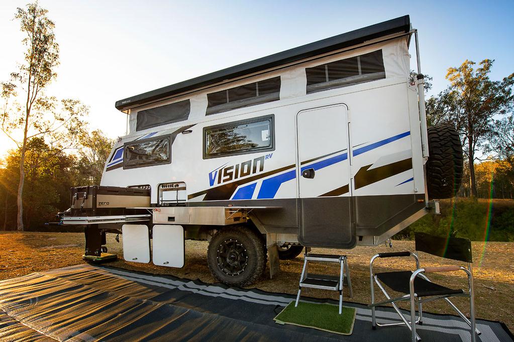 Vision Caravan parked in a peaceful forest setting