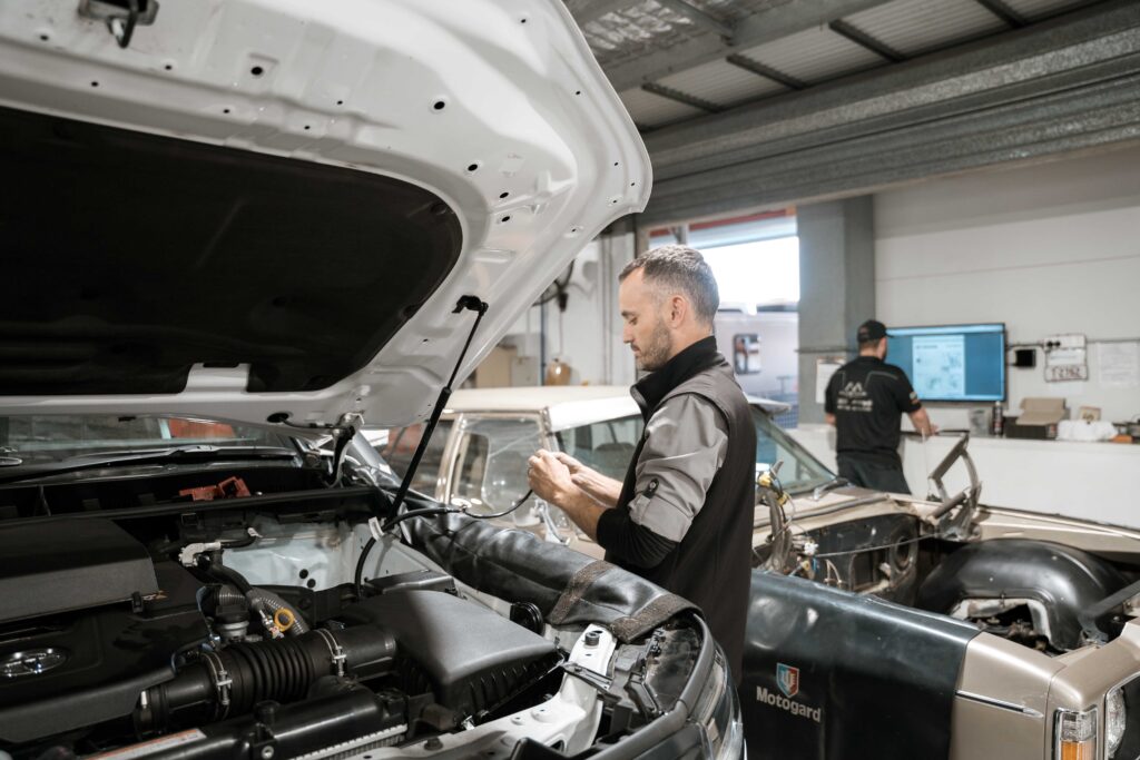 Expert technician evaluates the engine of a 4WD car as part of a comprehensive inspection process