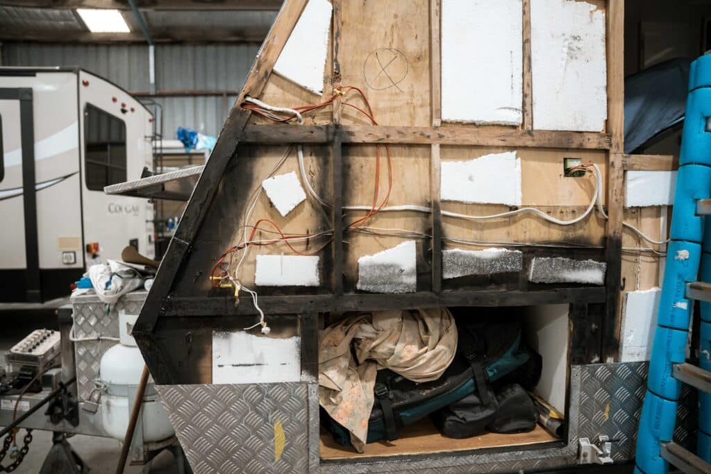 Skilled technicians assess and repair water damage inside a caravan