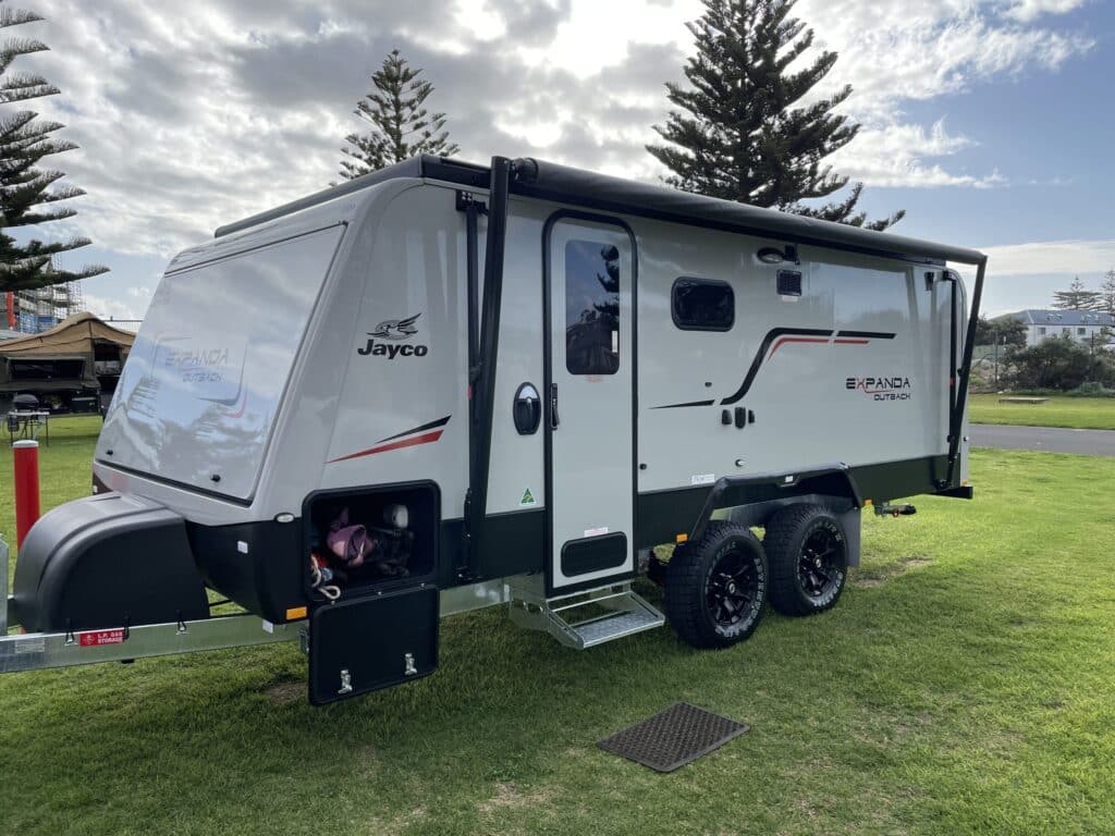 Jayco Expanda Make-Trax camper trailer parked in a scenic forest location