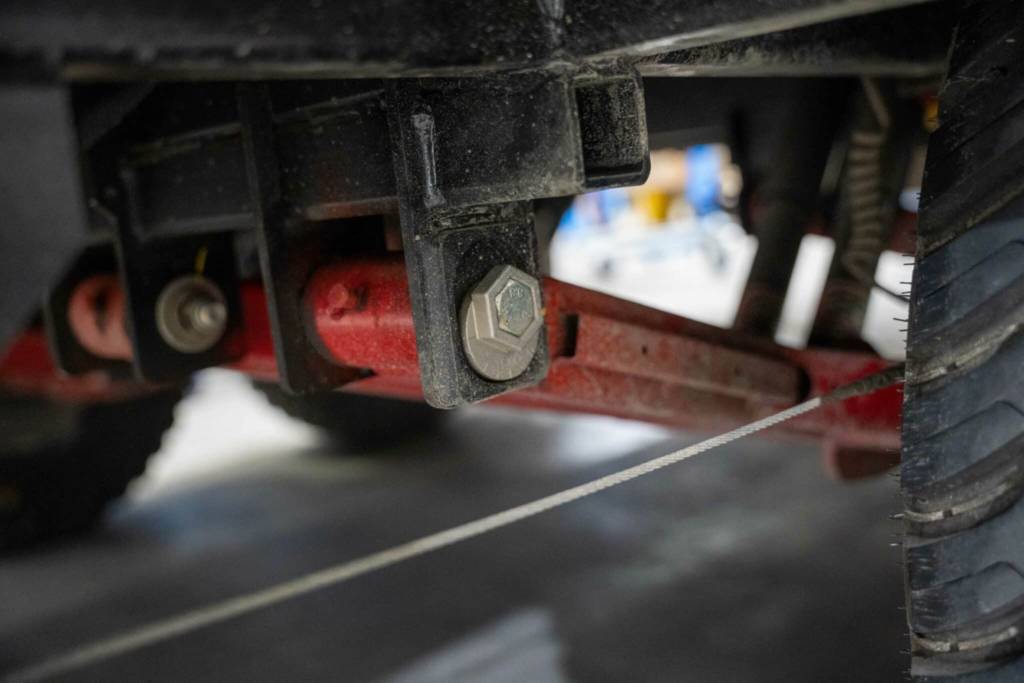 Caravan trailing arm independent suspension components beneath a caravan