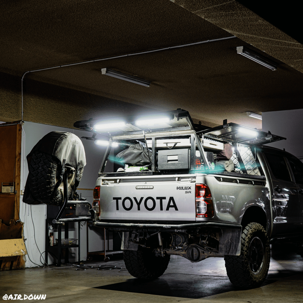 Truck inside a shop with flashing lights in the back