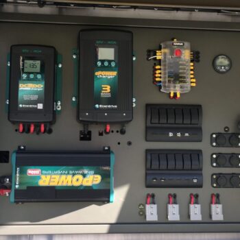 Efficient Enerdrive solar controller with MPPT and DC-to-DC charger mounted on black caravan wall