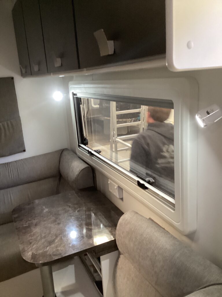 Caravan windows being resealed in a workshop