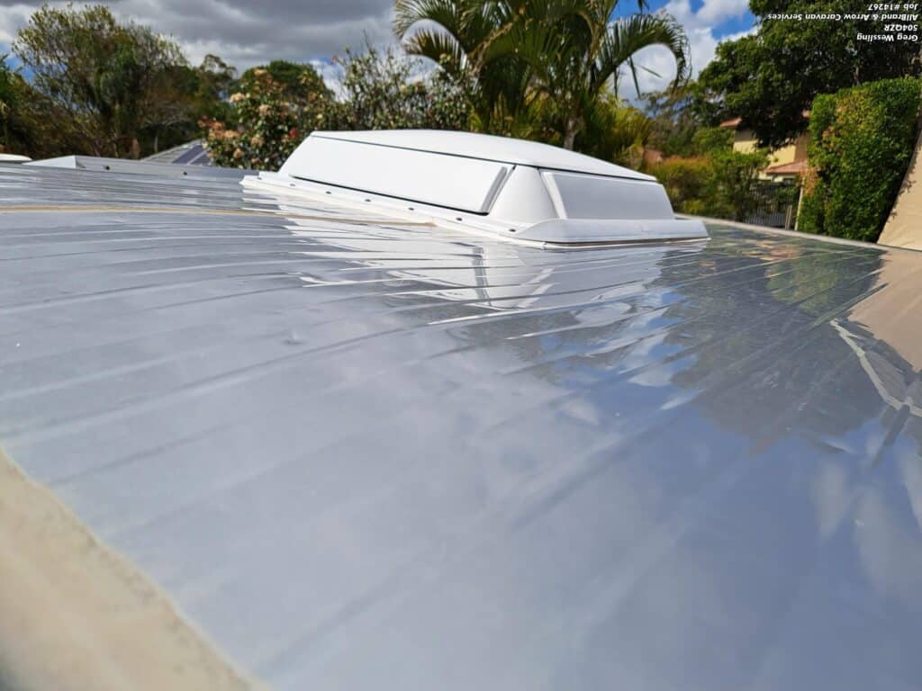 Close-up of hail damage on a caravan roof, highlighting the impact of the storm and need for repairs