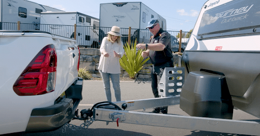 Police officer educates woman about caravan safety measures to ensure a secure journey