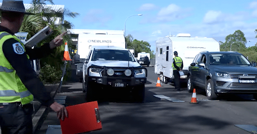 Police inspect parked caravan outside shop as part of routine safety check