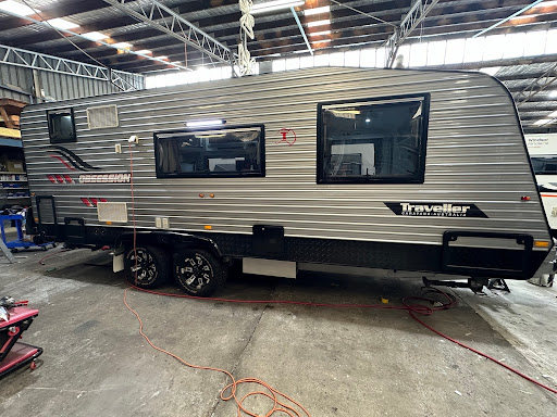 Caravan with dented siding and roof in need of repairs