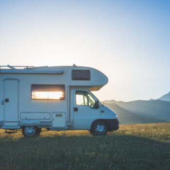10 Must-Have Carvanning Apps for Your Aussie Camping Trip! Sunset dramatic sky over camper van in Campo Imperatore highlands, Abruzzo, Italy. Epic clouds above unique highlands and rocky mountains landscape, alternative vanlife vacation concept.