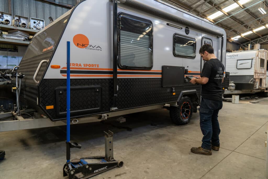 caravan service technician prepares inspecting a caravan for a safety certificate in brisbane queensland